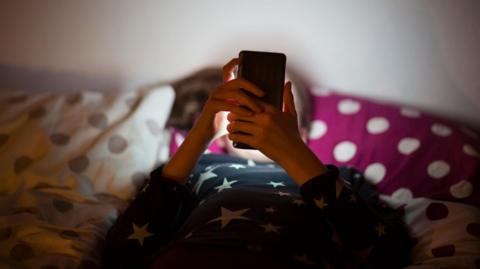 A young child using a smartphone