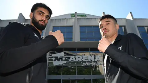 Adam Azim and Steve Claggett hold up their fists