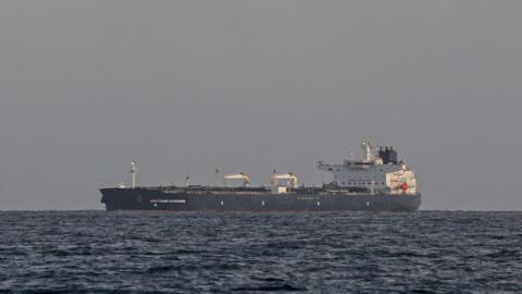 The Anatoly Kolodkin oil tanker, a black and white large vessel, is seen in the ocean from the port of Matanzas