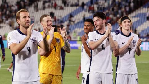England players - Harry Kane, Declan Rice, Jordan Pickford, Ollie Watkins and Anthony Gordon - clap fans after beating Serbia in World Cup qualifying match in Belgrade