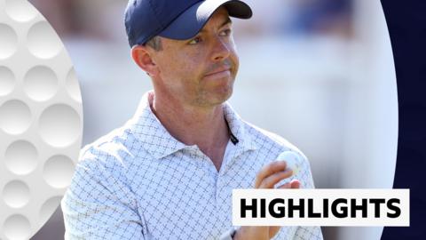 Rory McIlroy holding a ball and smiling at the crowd at the Scottish Open.