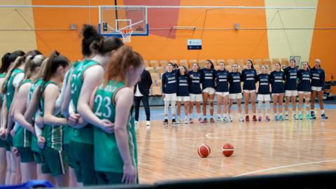 Ireland stand on the side of the court for the national anthems against Israel
