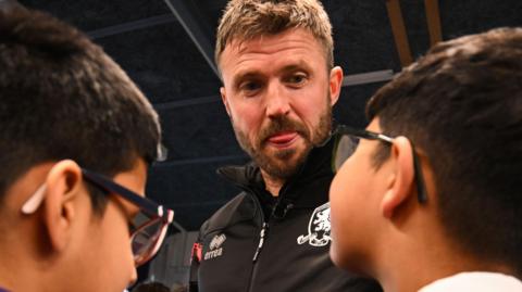 Michael Carrick with school children