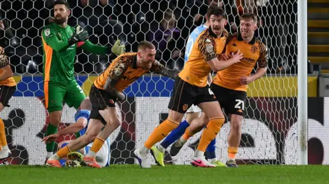 Hull players celebrate Callum Elder's own goal