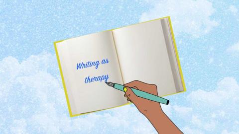 a cartoon book with the text "writing as therapy" and a hand holding a pen above the book.