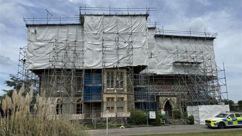 A building covered in metal scaffolding.