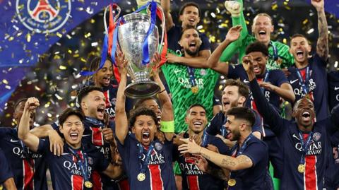 PSG players celebrate lifting the Champions League trophy
