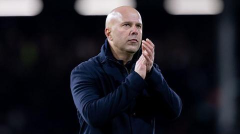 Arne Slot applauds the Liverpool fans at Fulham