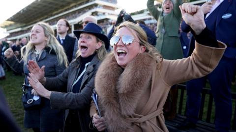 Cheltenham racegoers cheering in the crowd