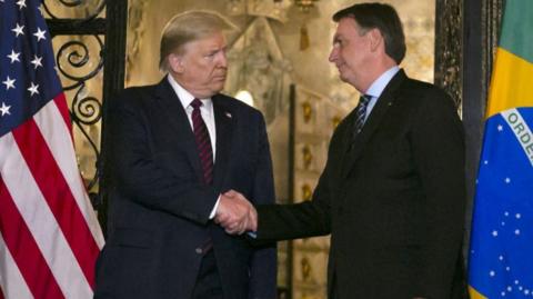 US President Donald Trump and Brazilian then-President Jair Bolsonaro shake hands at Mar-a-Lago in March 2020.
