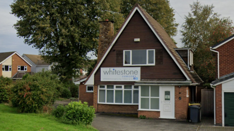 A house with a large triangular roof converted into a GP surgery