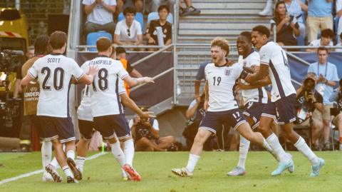 England players celebrating Elliott's second goal.  