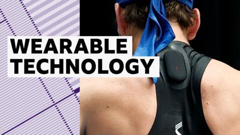 A tennis players wears a small black device on his back 
