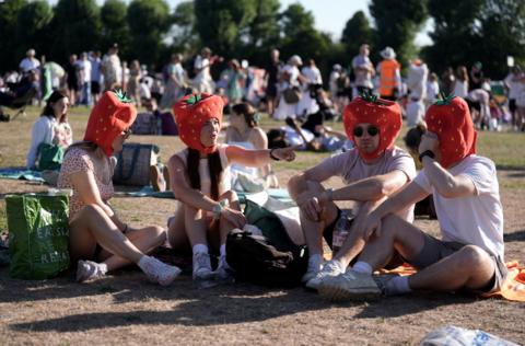 fan withs strawberry hats in the queue 