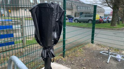 Pay-and-display parking machine with a cover over it