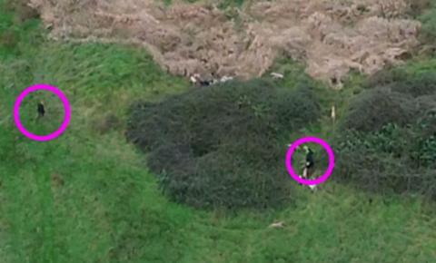 Aerial view of suspected illegal hunt, which shows two huntsmen near bushes