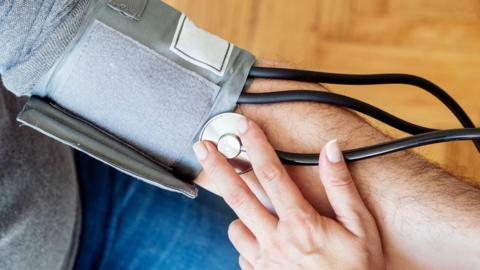 An anonymous man gets his blood pressure taken