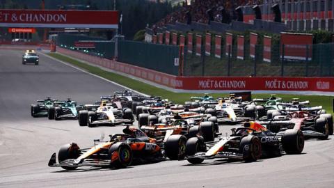 McLaren's Oscsar Piastri with Red Bull's Max Verstappen alongside leads the field into the first corner of the Belgian Grand Prix sprint race
