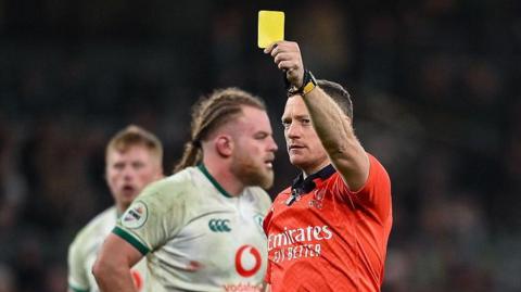 Matthew Carley shows yellow card