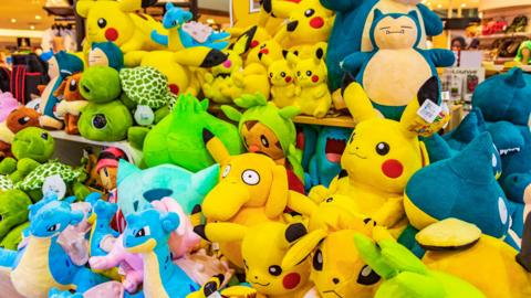 A colourful selection of Pokemon plush toys, including Pikachu, at Bangkok airport Thailand.