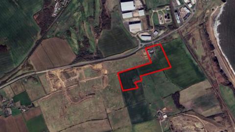 An aerial map shows the parcel of land where the 149 houses would be built.