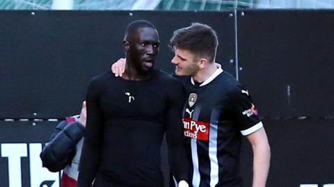 Notts County players celebrate their second goal against Tranmere