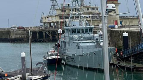 A small boat next to a large Border Force vessel on Ramsgate harbour