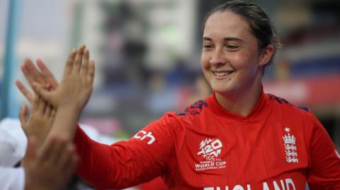 Alice Capsey high fives a team-mate during the ICC Women's T20 World Cup