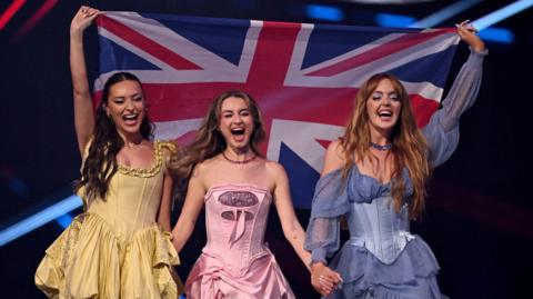 Remember Monday hold aloft a Union flag as they take part in the 2025 Eurovision Song Contest