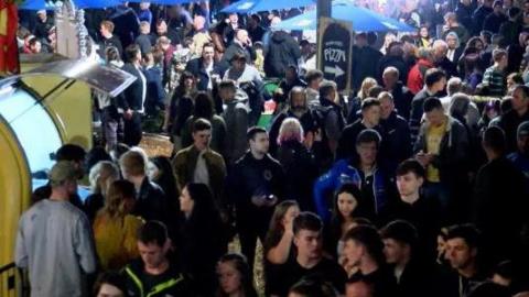 Crowds of revellers in Douglas at night.