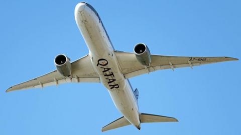 The belly of a Qatar Airlines jumbo jet as seen in the sky