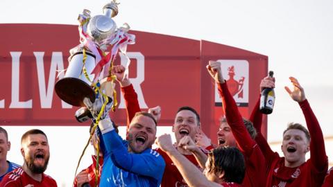 Connah's Quay Nomads players celebrate their 2024 JD Welsh Cup win 