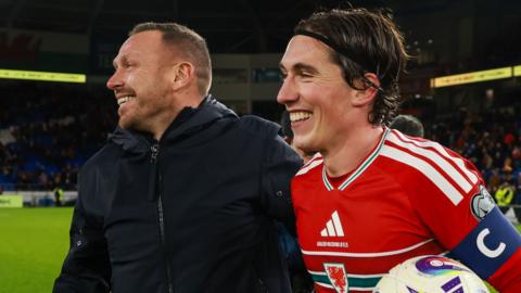 Craig Bellamy and Harry Wilson together smiling after a game