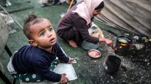 Palestinian children at a camp set up in Al-Durra Stadium in the central Gaza Strip