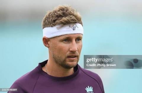 Joe Root in nets training, wearing a purple top and a white sweat band on his head
