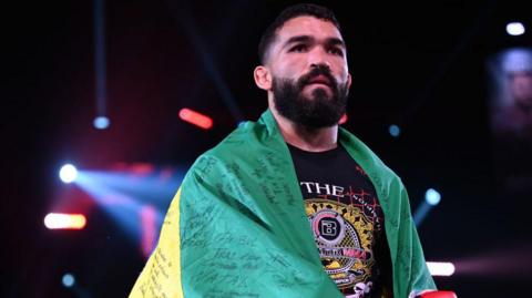 Patricio 'Pitbull' Freire with a Brazil flag over his shoulders