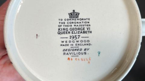 The bottom of a rare Wedgwood coronation mug in yellow