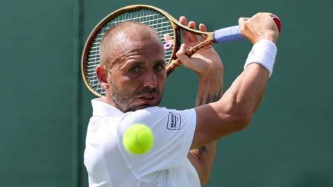 Dan Evans hits a backhand
