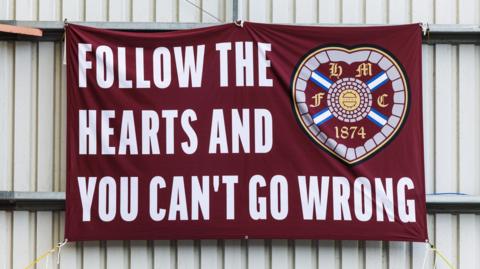 A Hearts flag draped at a managerless Tynecastle
