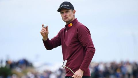 Justin Rose raises his golf ball after making a putt at the 152nd Open championship at Royal Troon in 2024
