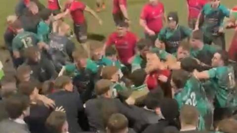 Blurry video footage showing a fight between Cardiff and Swansea university players