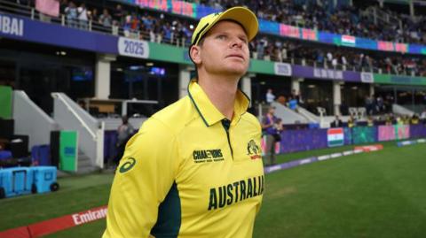 Steve Smith looks up after walking on to the pitch