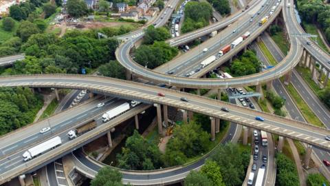 Aerial shot showing the intersection of roads at Spaghetti Junction, with carriageways peeling off from each other between the linked roads.