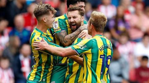 Nat Phillips is congratulated by West Bromwich Albion teammates after scoring at Stoke City