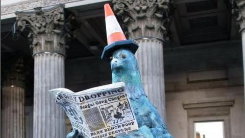 A pigeon statue which is sitting on top of the Duke of Wellington