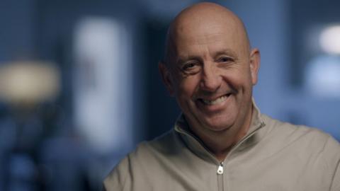 Gary McAllister smiling with a blurred background