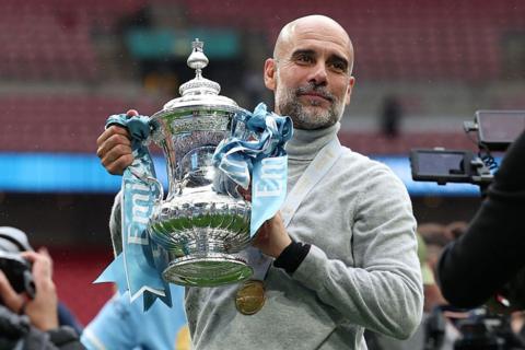 pep guardiola holding the FA Cup