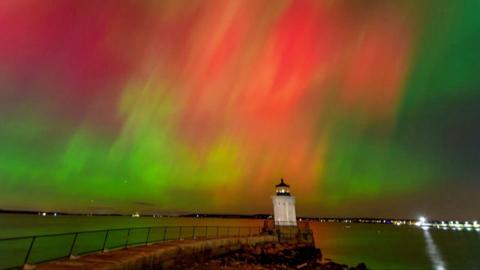 Northern lights illuminate the night sky.