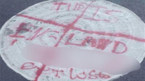 Roundabout in Knightorpe Road, Loughborough after having graffiti written on to it
