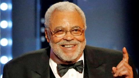 James Earl Jones smiling on stage as he received a special Tony Award in 2017. He is wearing a tuxedo.